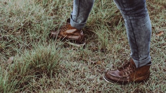 Close-up of durable gardening boots on a grassy path.