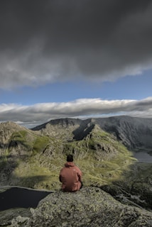 man sitting on rock