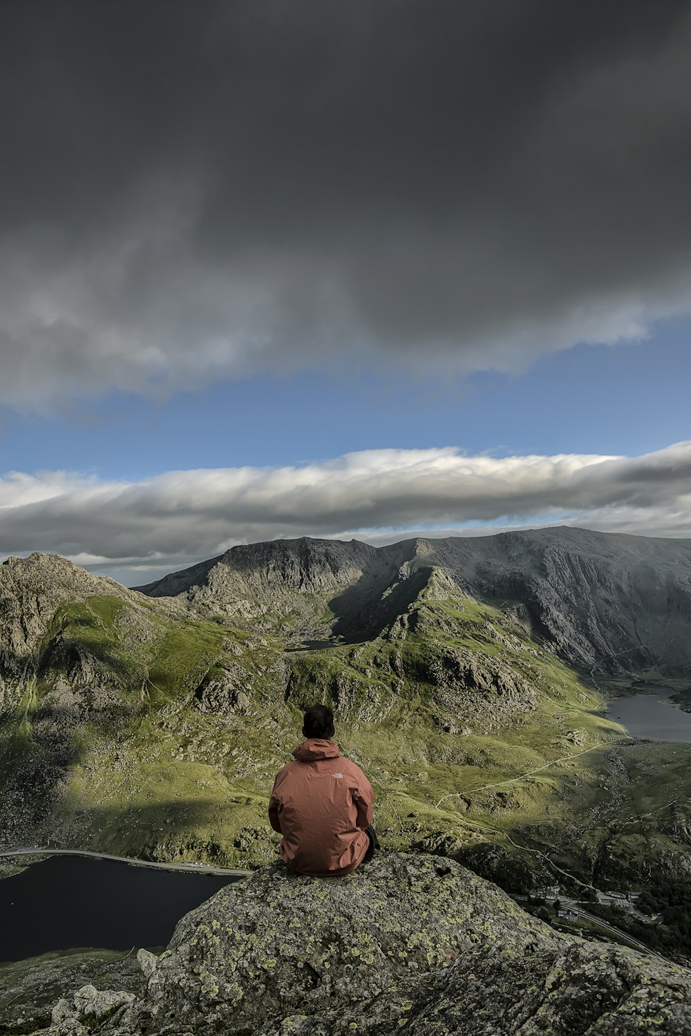 man sitting on rock