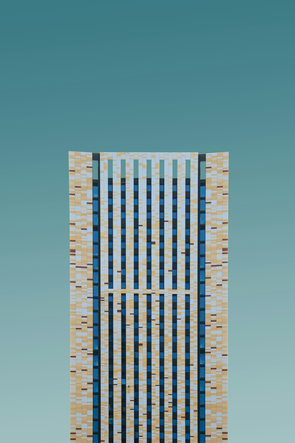 a tall building with a blue sky in the background