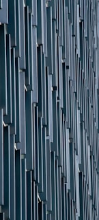 Vertical rectangular panels create a repeating geometric pattern on a modern building facade.