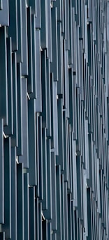 Vertical rectangular panels create a repeating geometric pattern on a modern building facade.