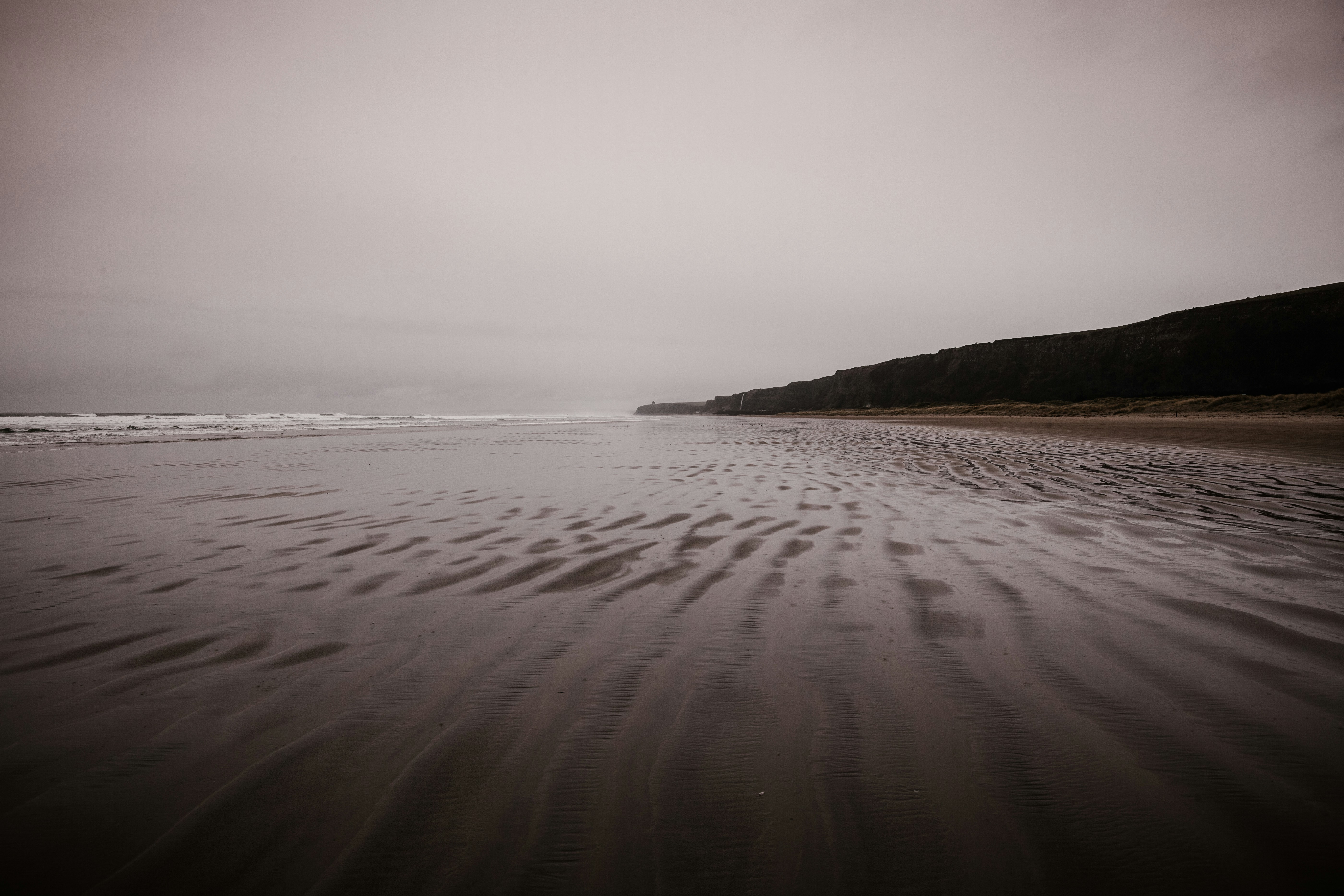 Una foto en blanco y negro de una playa de arena