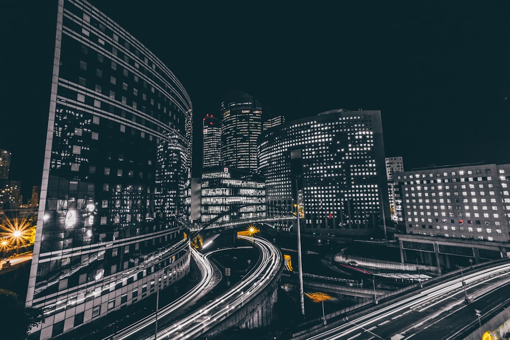 time lapse photography of vehicle passing on road near buildings