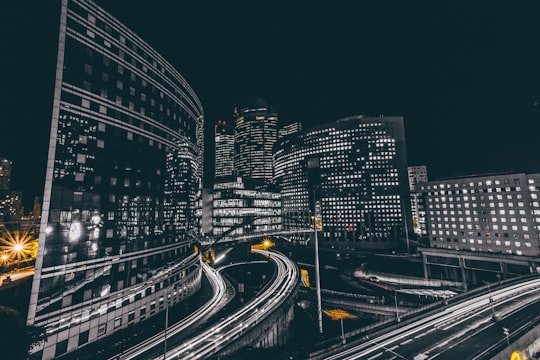 time lapse photography of vehicle passing on road near buildings in La Défense France