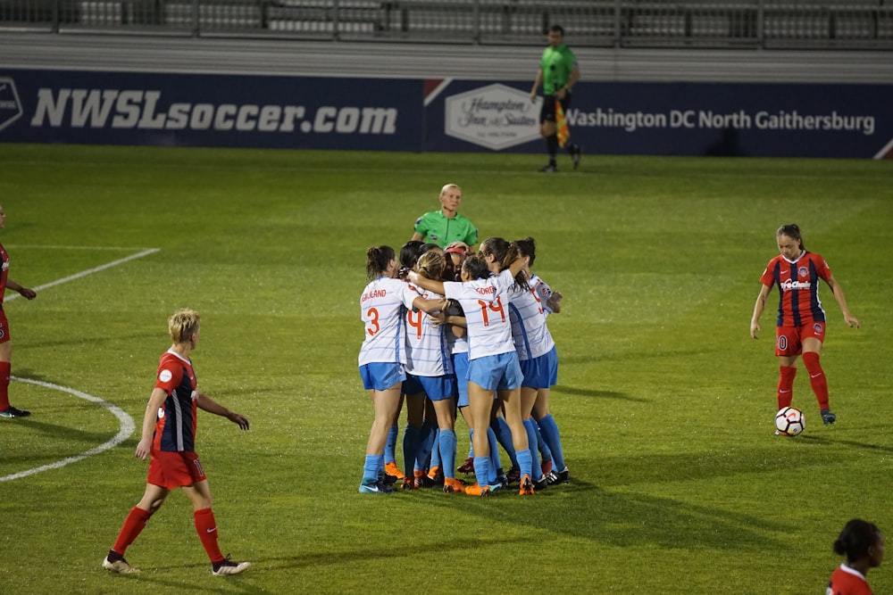 group of soccer player hugging