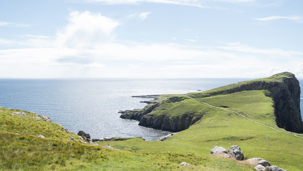 green island under blue and white sky