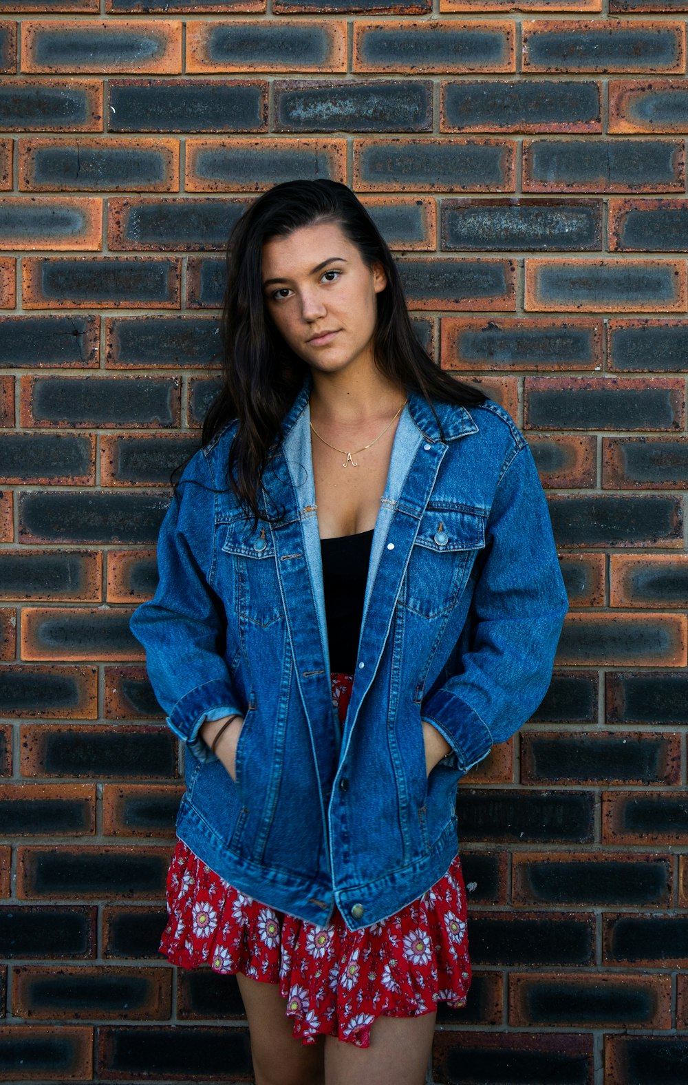 woman wearing blue denim button-up jacket taking a selfie