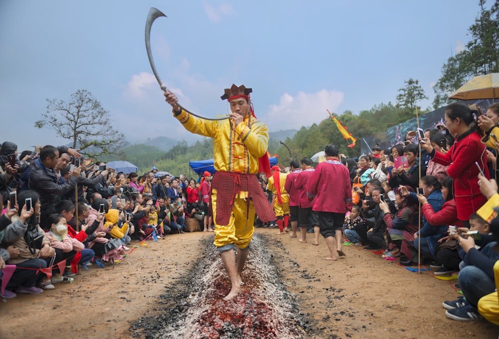 man performing traditional dance while holding sword