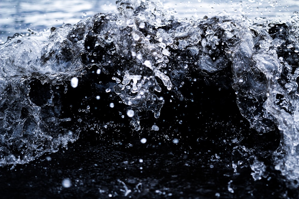 the water is splashing on top of the rocks