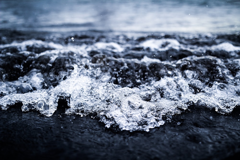 a black and white photo of water and rocks