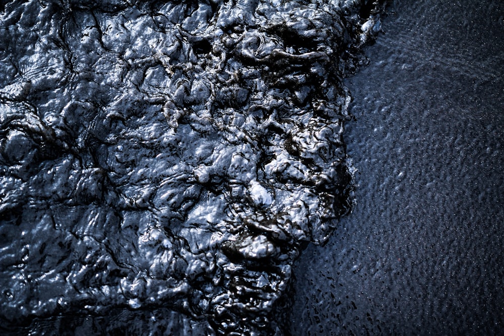 a close up of a black substance on a black surface