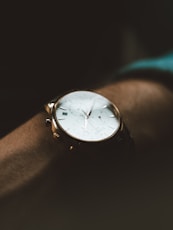 person wearing white chronograph watch