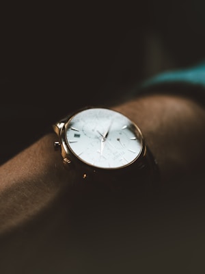 person wearing white chronograph watch