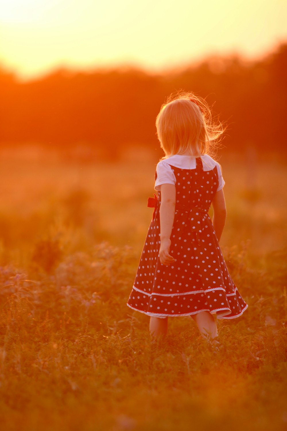 selective focus photography of girl wearing black and white polka-dotted dress