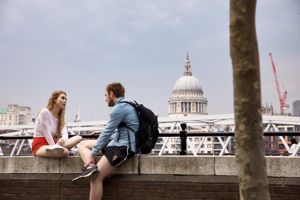 man and woman talking at the balcony