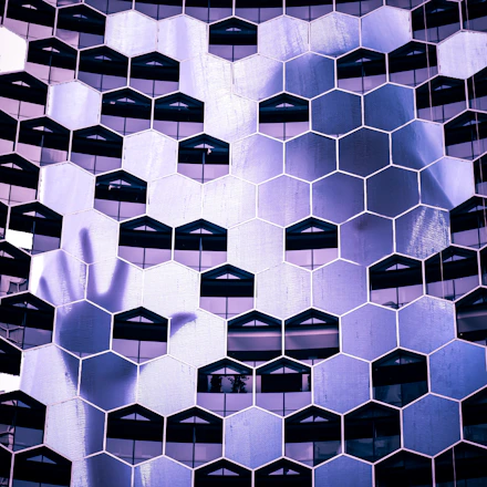A sleek navy and gold hexagonal column symbolizing strategic architecture.