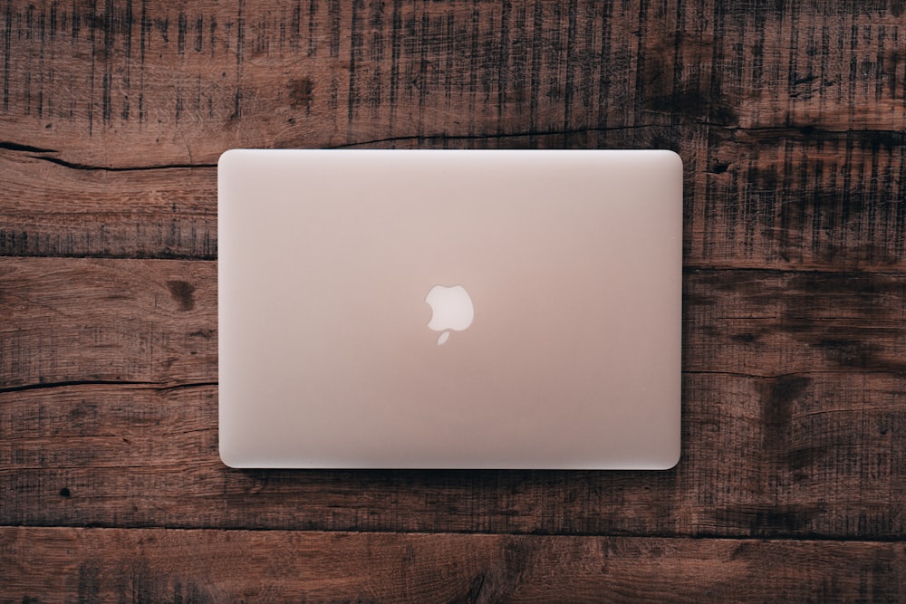 closed silver MacBook on table