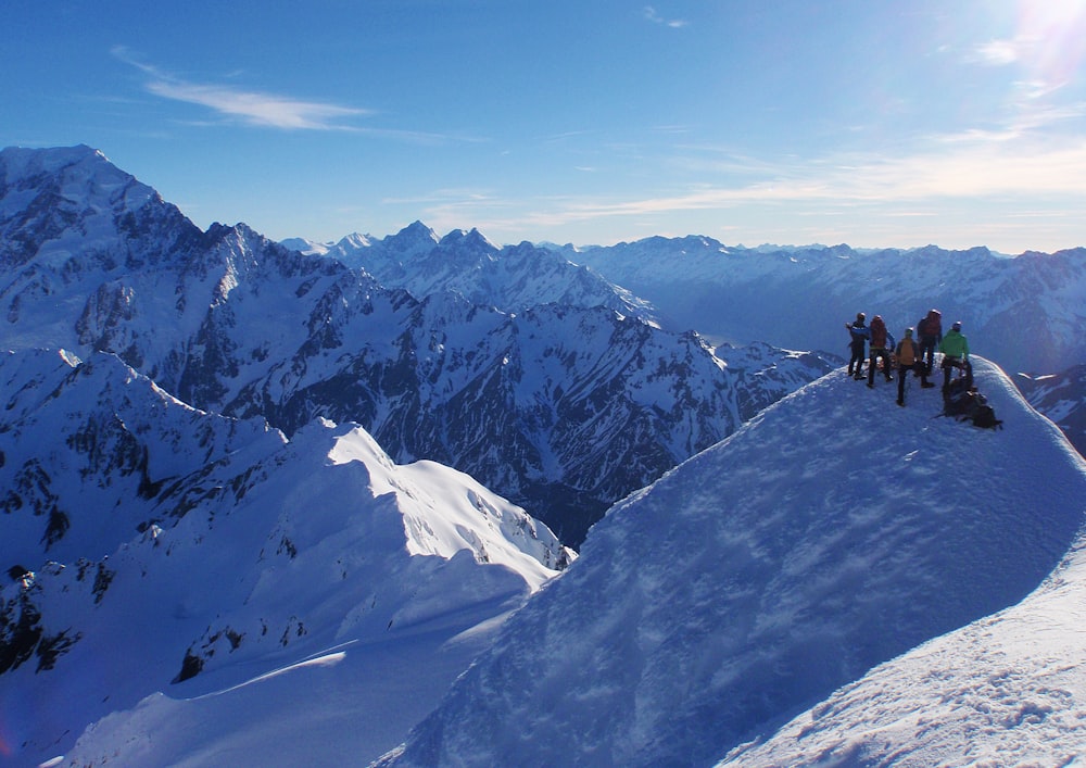 people trekking on mountain top