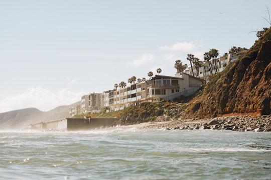 brown and white concrete building near sea shore in Malibu United States