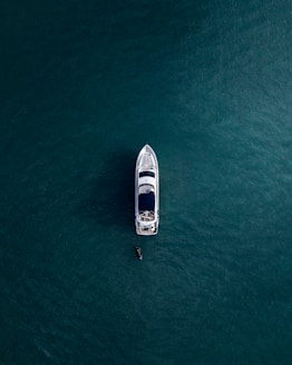 aerial photography of white yacht on calm waters