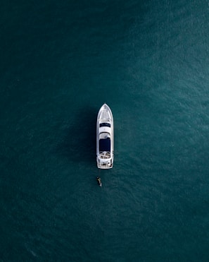 aerial photography of white yacht on calm waters