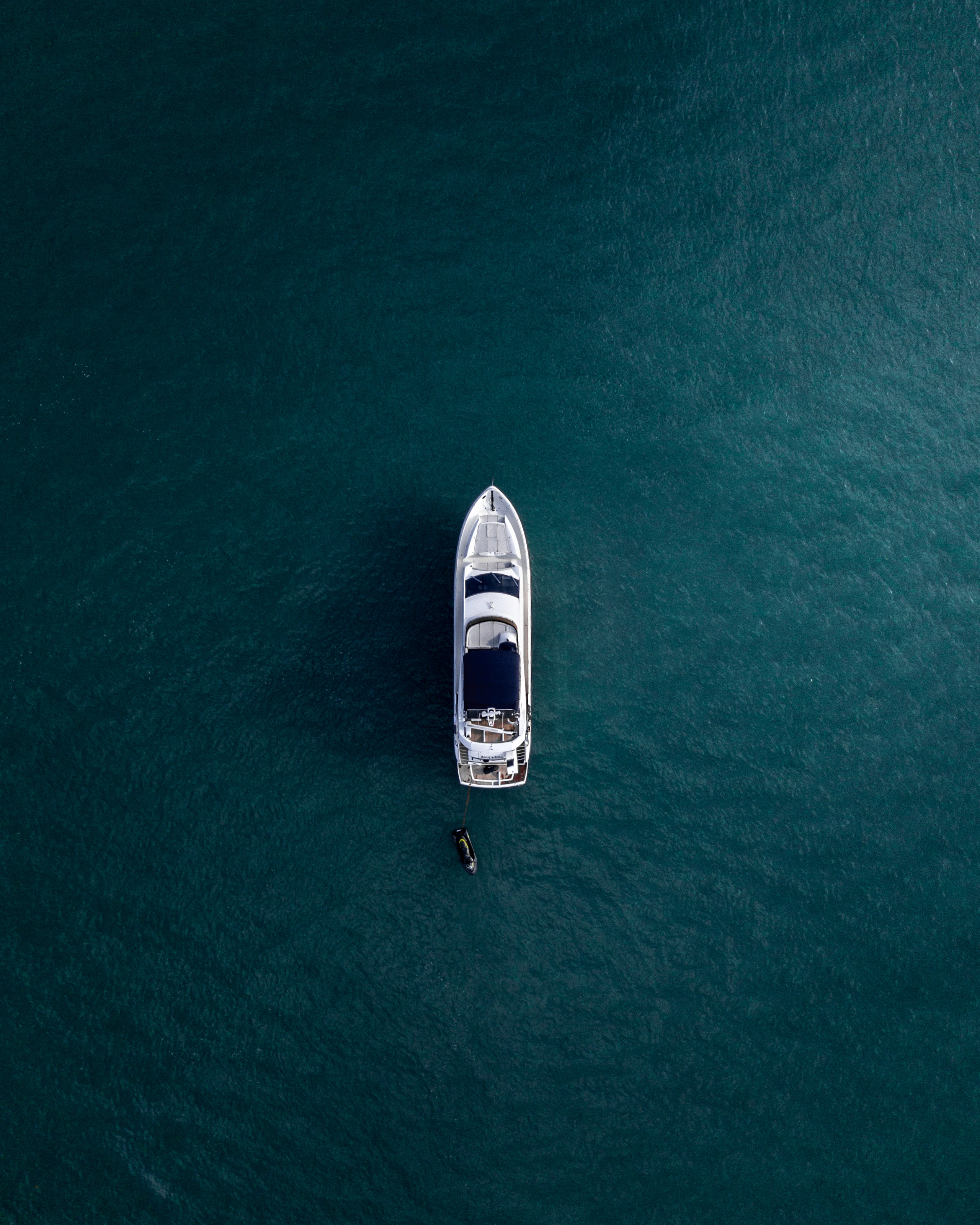 Aerial view of a white yacht on calm water
