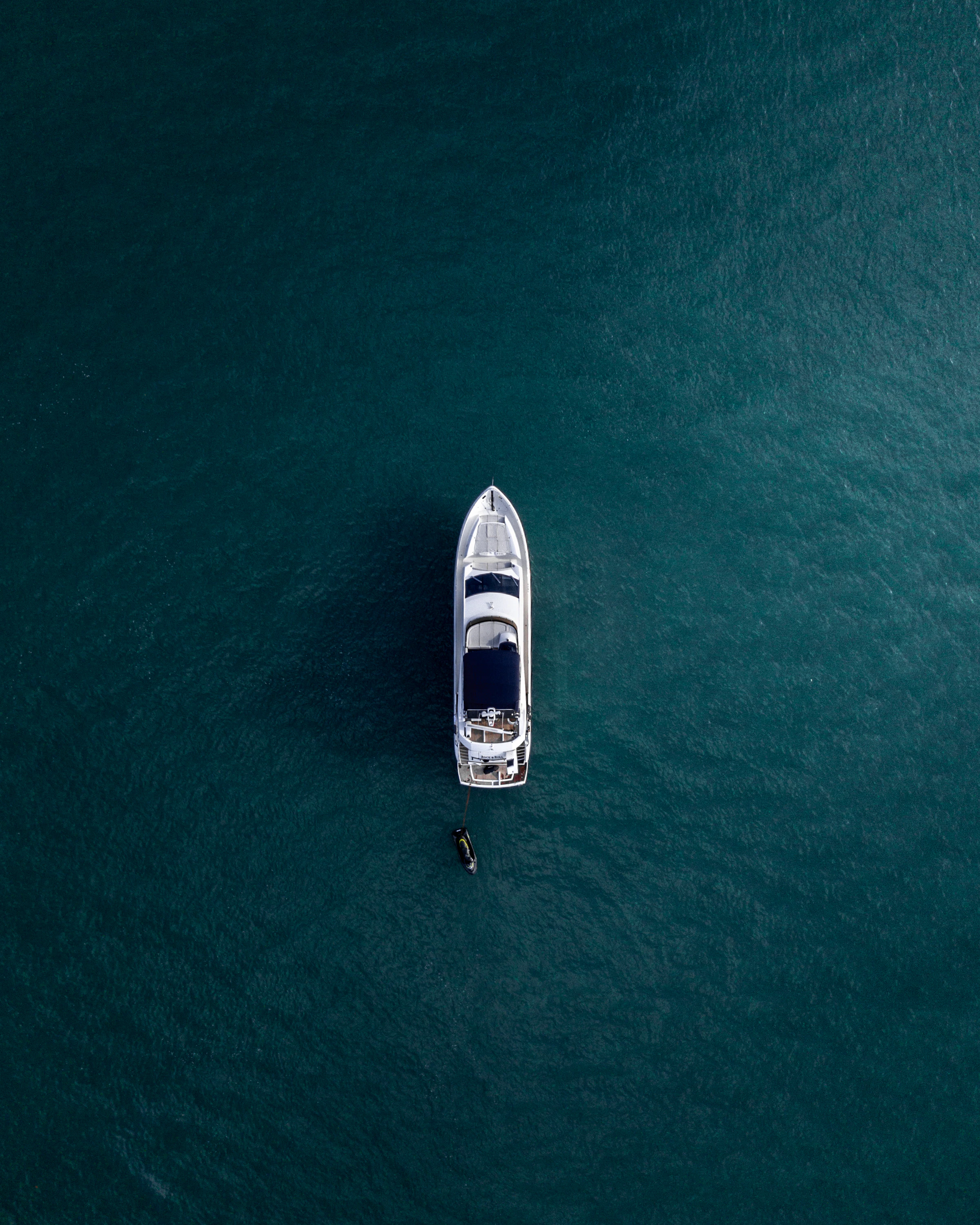 A white yacht sailing across deep blue water