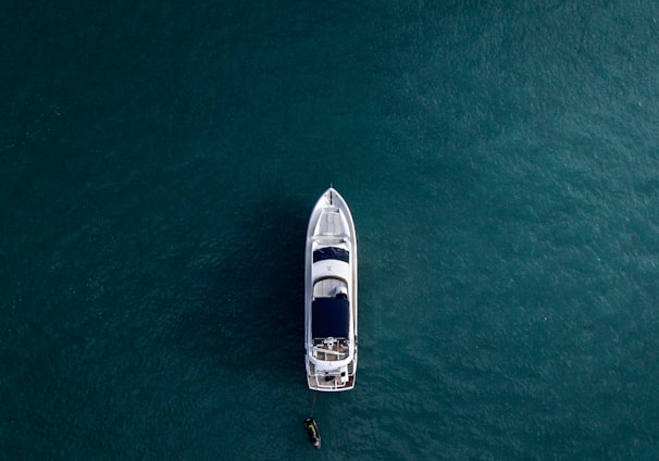 aerial photography of white yacht on calm waters