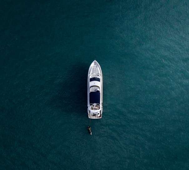 aerial photography of white yacht on calm waters