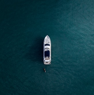 aerial photography of white yacht on calm waters