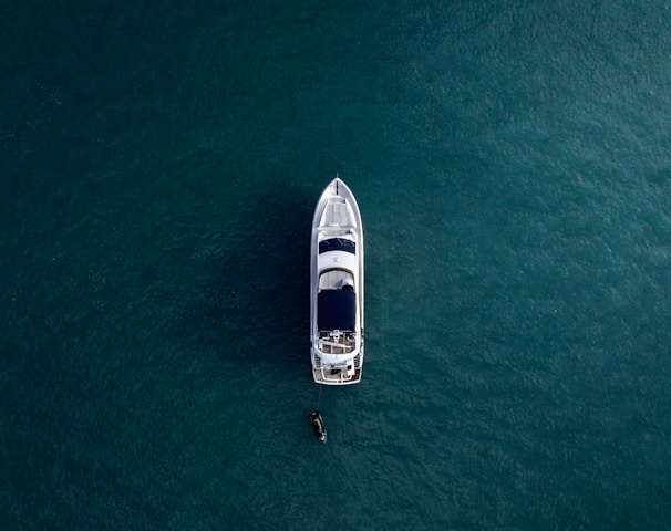 aerial photography of white yacht on calm waters