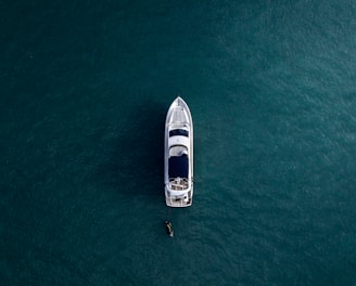 aerial photography of white yacht on calm waters