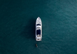 aerial photography of white yacht on calm waters