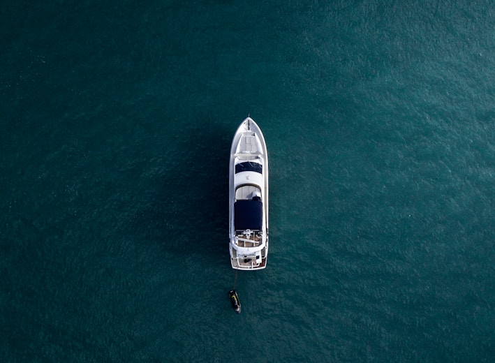 aerial photography of white yacht on calm waters