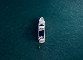 aerial photography of white yacht on calm waters