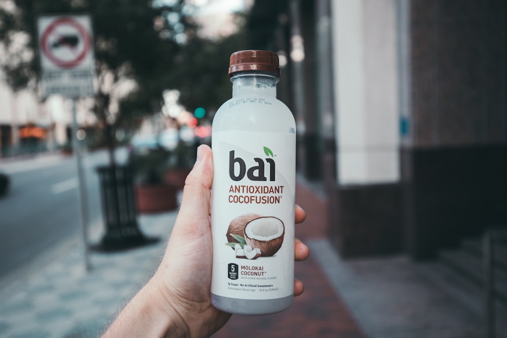 person holding Bai antioxidant cocofusion drink bottle