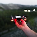 person holding black and red quadcopter