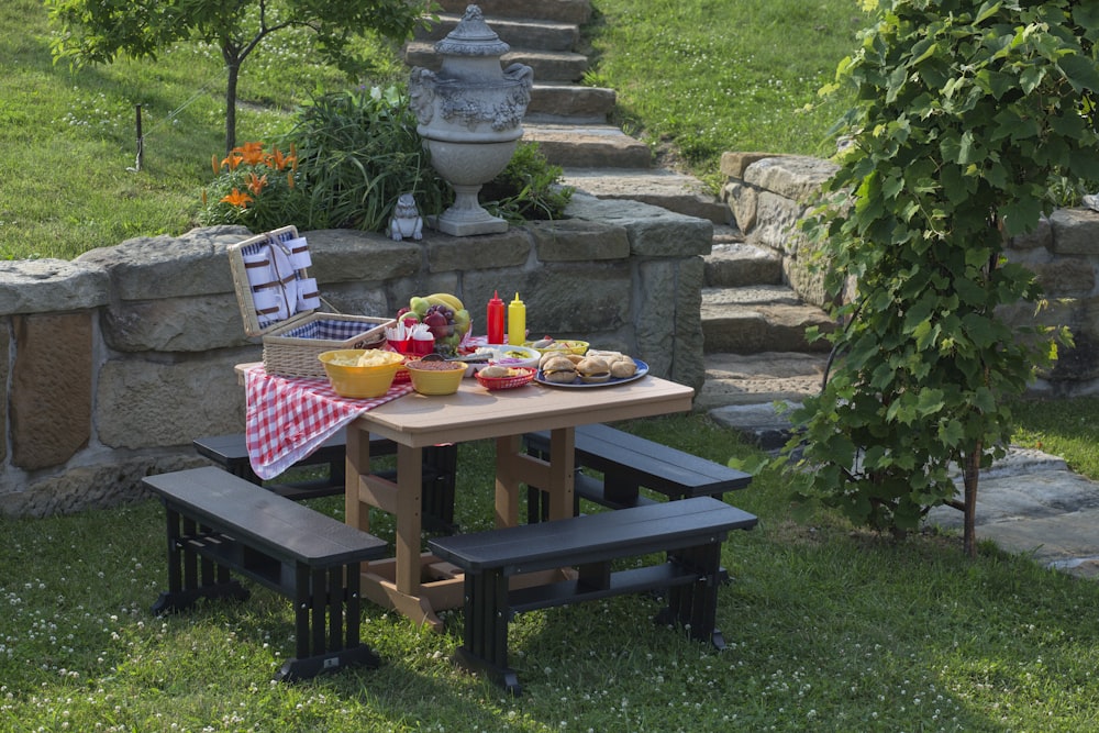 beige and black picnic table with variety of sandwiches prepared during daytime