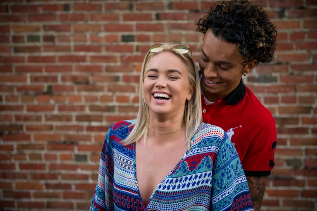 Casual moment of a man and woman laughing together while wearing Lumina Apparel's comfortable yet sophisticated daywear.