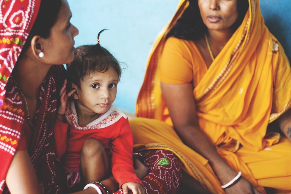 two women and a child taking picture