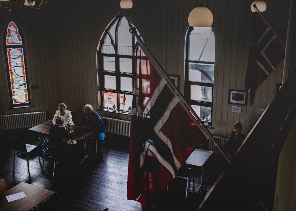 group of people talking in front of table