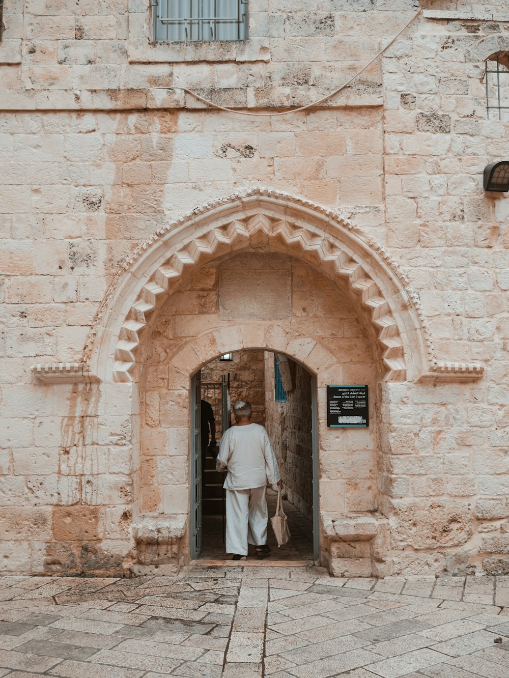 woman entering the concrete house