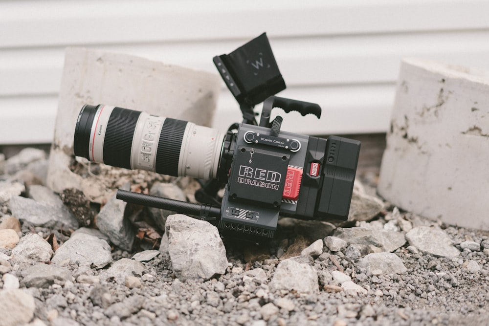 person showing black and grey camcorder on ground