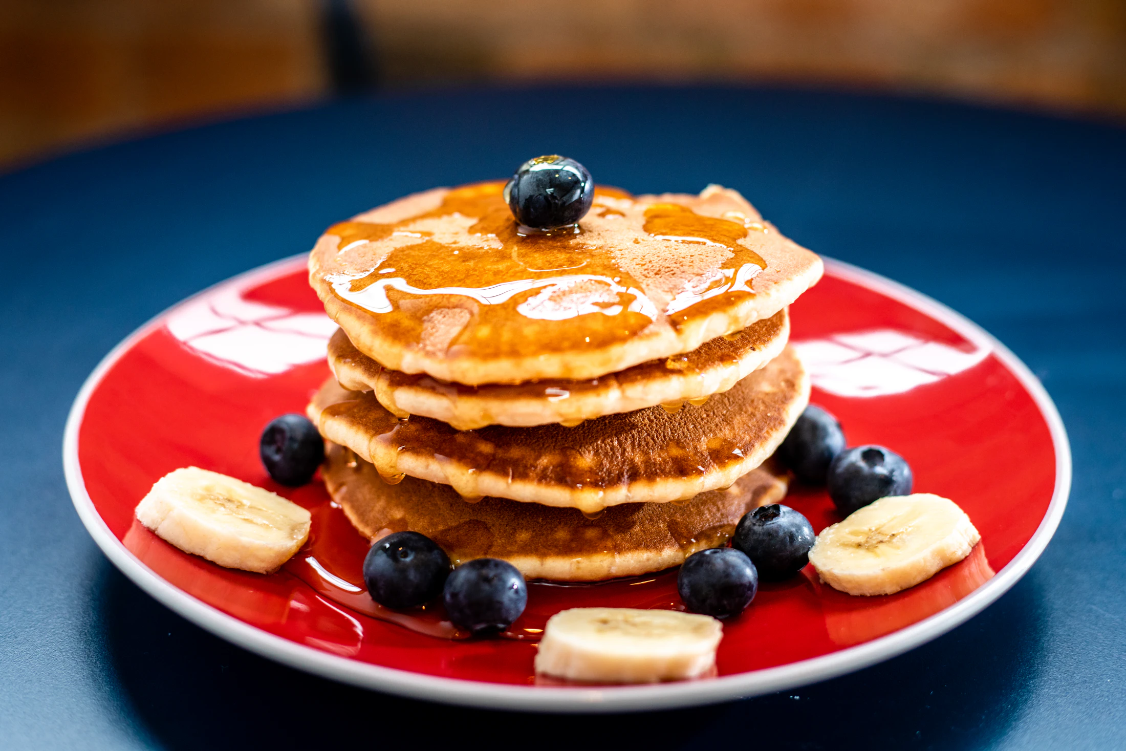 Fluffy mini pancakes with banana and blueberries