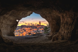 brown cave with over-view of city