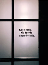 A frosted glass office door with vintage typewriter text etched subtly.