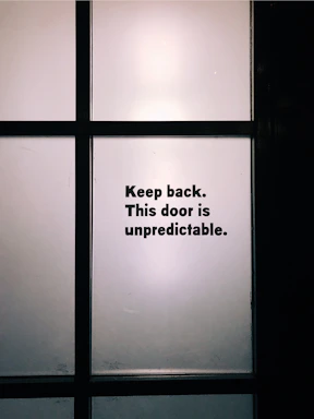 A frosted glass office door with vintage typewriter text etched subtly.