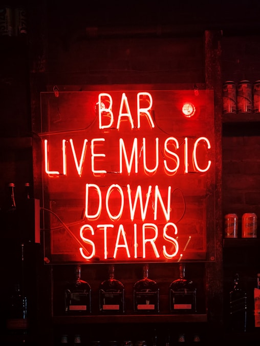 Neon bar and live music sign glowing at night