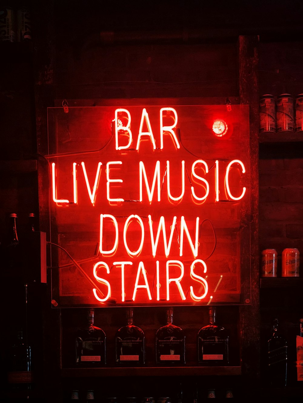bar live music down stairs neon light signage